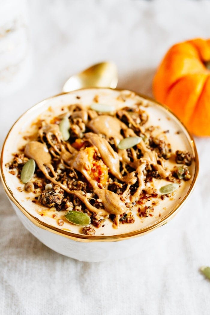 This pumpkin pie yogurt bowl is the perfect fall breakfast. Loaded with protein-packed yogurt, pumpkin puree, pumpkin pie spice and all your favorite toppings! Pumpkin pie yogurt bowl topped with pumpkin seeds, granola and a drizzle of almond butter.