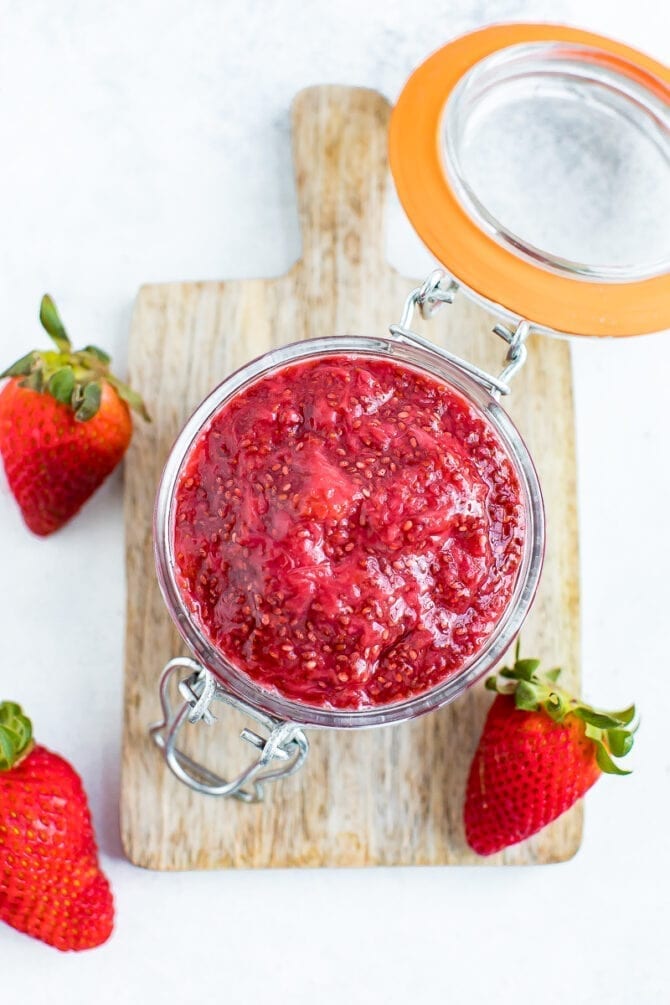 Overhead photo of strawberry chia jam in a glass jar.