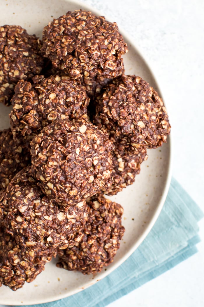 peanut butter chocolate no bake cookies Plate full of peanut butter chocolate healthy no bake cookies with a folded blue napkin below the plate.