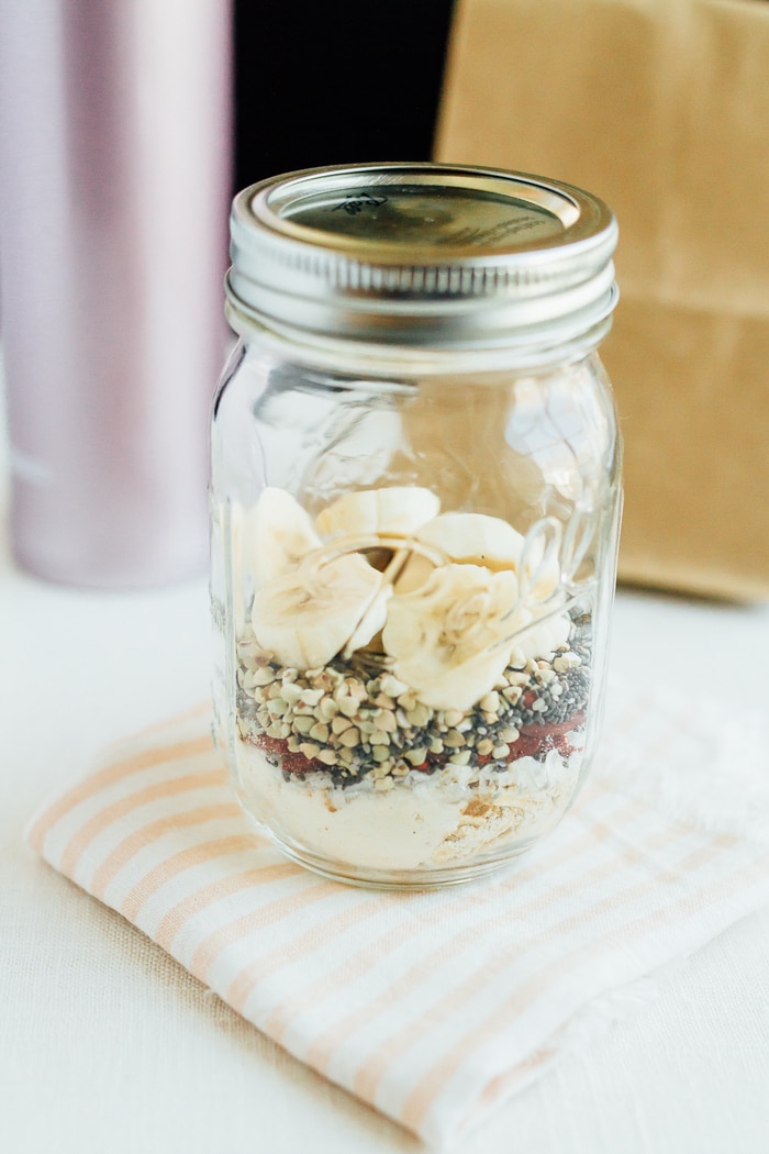 Cereal lovers rejoice! This healthy superfood cereal is loaded with nutrient-dense foods, plus it's gluten free, has no added sugars and packs a nice punch of omega-3s and protein. Put the cereal in a mason jar for easy transport when you need a quick on-the-go breakfast! A closed mason jar with banana slices, goji berries, oats, and chia seeds.