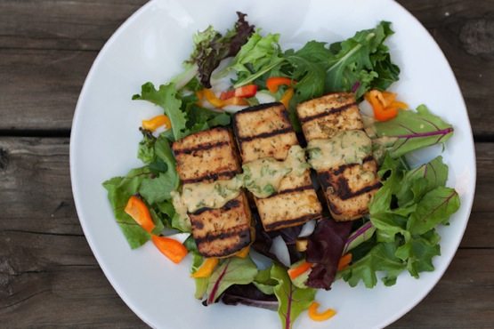 This lemon basil tofu is marinated in a zesty fresh basil sauce and grilled to perfection. It's easy and absolutely delicious! Lemon basil tofu served over a bed of mixed greens.