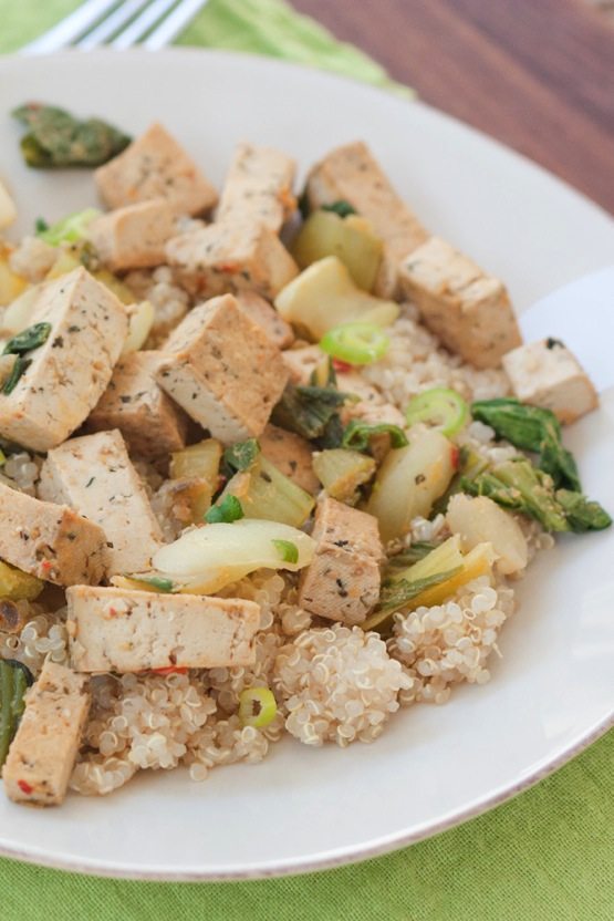 Quick and Healthy Dinner: Tofu and Bok Choy Stir Fry Tofu bok choy stir fry served over quinoa on a white plate topped with green onions.