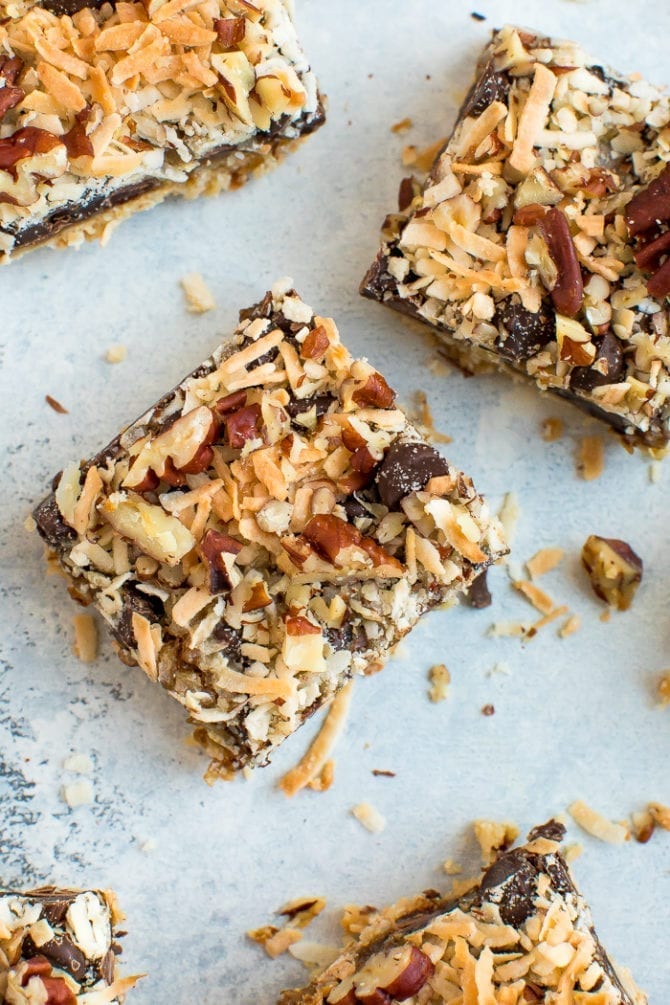 Healthier square magic cookie bars. An almond flour cookie crust topped with coconut caramel, coconut, pecans, and chocolate chips.