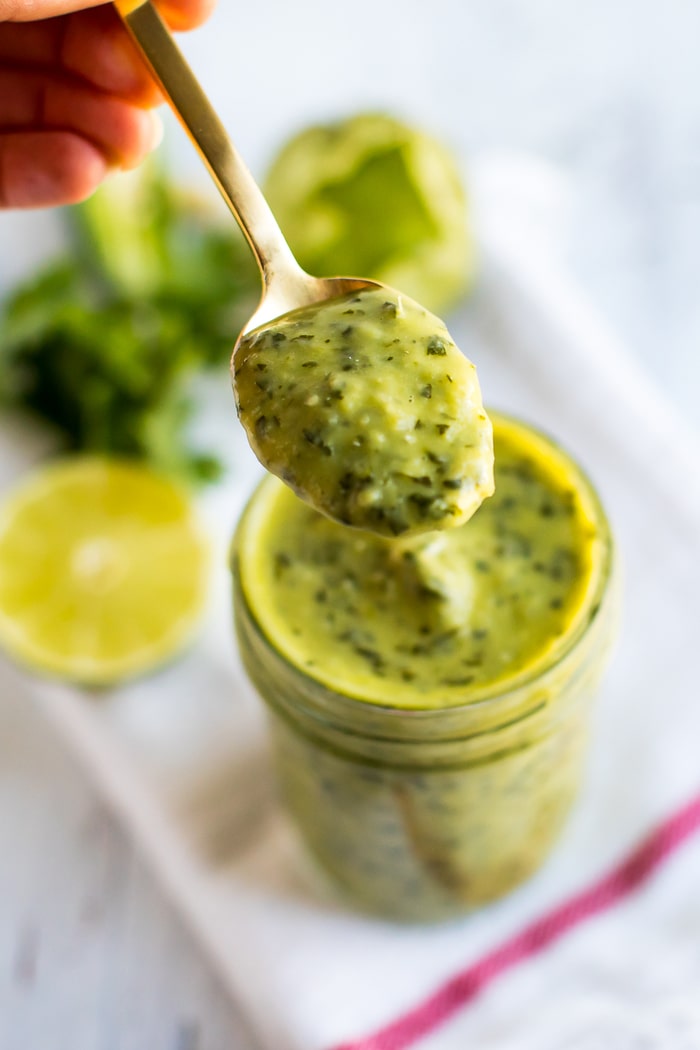PIN THIS --> Chopt Mexican Goddess Dressing Recipe Chopt Mexican Goddess with tomatillos and avocado in a mason jar with a gold spoon.