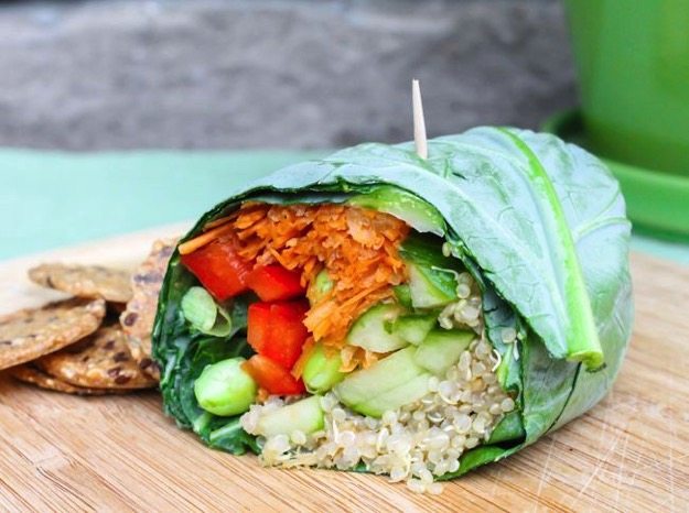 Edamame Quinoa Collard Wrap by Eat Spin Run Repeat Edamame Quinoa Collard Wrap sitting on wood cutting board