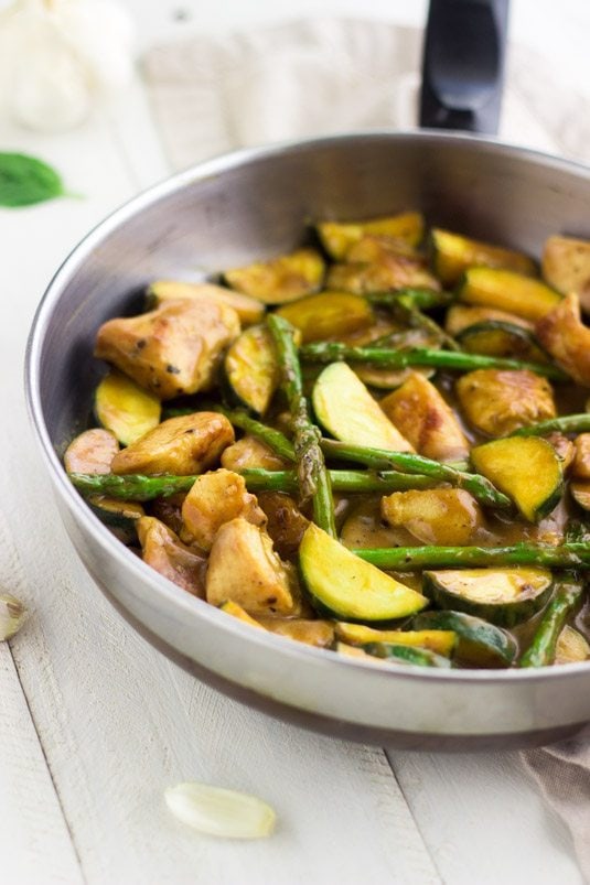 Honey Mustard Chicken Stir Fry by Food Faith Fitness Honey Mustard Chicken Stir Fry in a silver pan on white wood counter