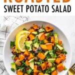 Bowl of roasted sweet potato salad with cranberries, onion, spinach and avocado.