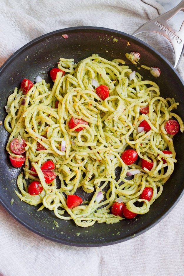 Rutabaga Pasta with a Creamy Pesto Sauce Rutabaga Pasta with tomatoes and red onion tossed in a Creamy Pesto Sauce in a sauté pan.