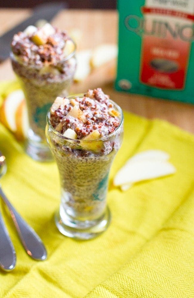 Apple Cinnamon Overnight Quinoa -- Turn leftover quinoa into a protein-packed breakfast with this simple, seasonal apple cinnamon overnight quinoa recipe that's gluten-free and vegan. A glass jar of overnight quinoa is in focus with a blurry glass in the background.