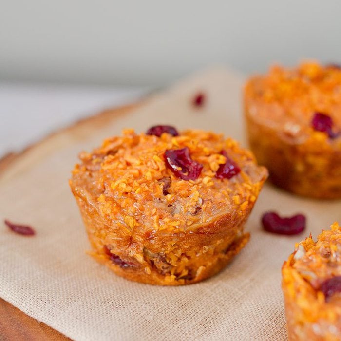 Spiralized cranberry pecan sweet potato muffins made with riced sweet potato noodles. They’re moist, filling and delicious served warm straight from the oven or at room temperature. Up close photo of muffin.