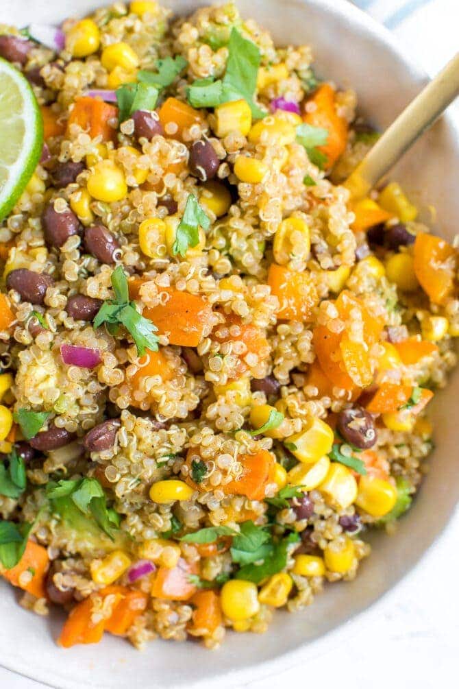 Close up photo of southwestern quinoa salad with peppers, sweet potato, black beans, and corn.