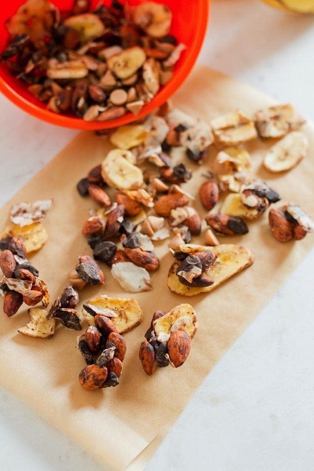 PIN THIS --> Chunky Monkey Trail Mix Trail mix on parchment paper. Banana chips, chocolate chips, coconut flakes and almonds.