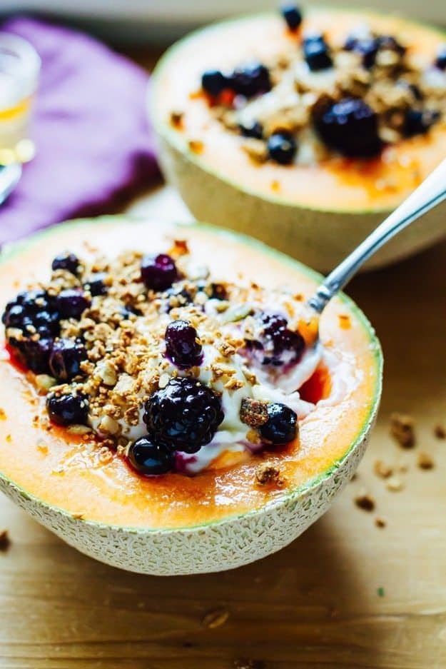 Save the recipe for these delicious Cantaloupe Breakfast Bowls for later! Cantaloupe Breakfast Bowls filled with Greek Yogurt, Berries, Granola and Honey