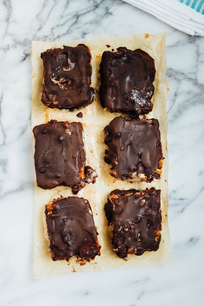 Pin this image to save this delicious recipe for Chocolate Caramel Banana Ice Cream Bars! Chocolate Caramel Banana Ice Cream Bars on parchment paper.