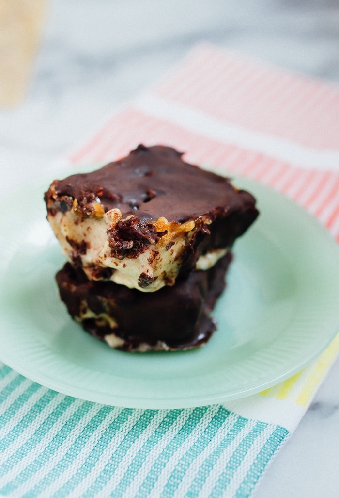 Pin this image to save this incredible Chocolate Caramel Banana Ice Cream Bars recipe for later! Chocolate Caramel Banana Ice Cream Bars stacked on a turquoise plate.