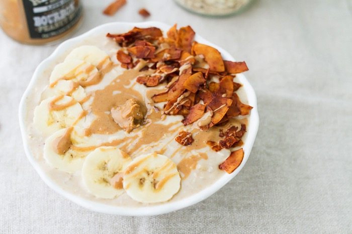 Overnight oats fit for the King with a combo of nutty peanut butter, fresh banana slices and crispy coconut bacon! A bowl of peanut butter banana and bacon overnight oats.
