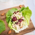 Almond butter chicken salad made with almonds, celery and grapes in lettuce cups.
