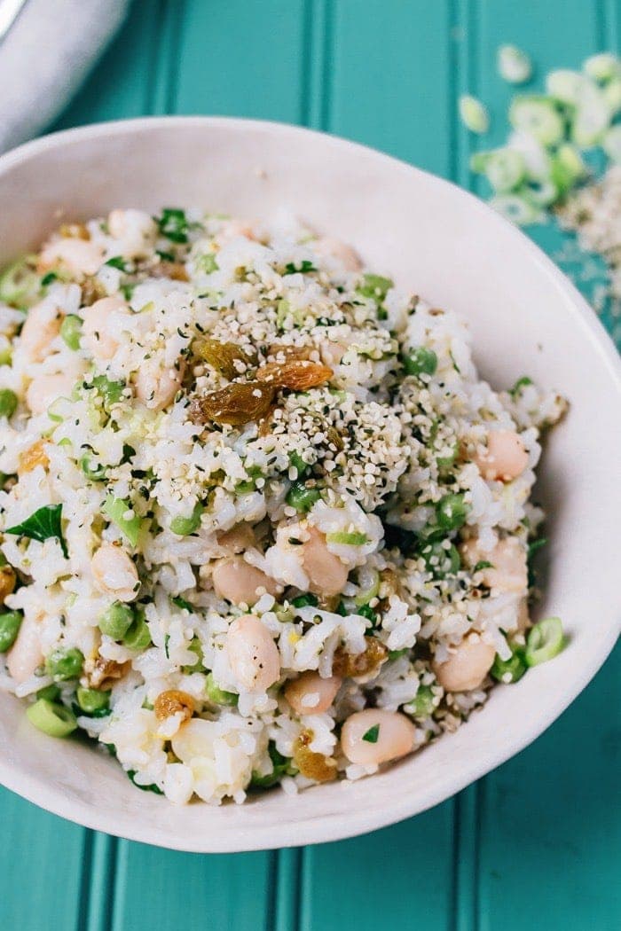 This Mediterranean-inspired rice salad with creamy cannellini beans and Hemp Hearts can be served warm or chilled and makes a lovely vegetarian main or a flavorful side. Lemony rice salad with white beans, green beans, hemp hearts and golden raisins.