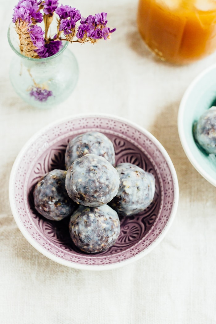 No Bake Blueberry Muffin Donut Holes // vegan and gluten-free No bake blueberry muffin donut holes in a small purple bowl.