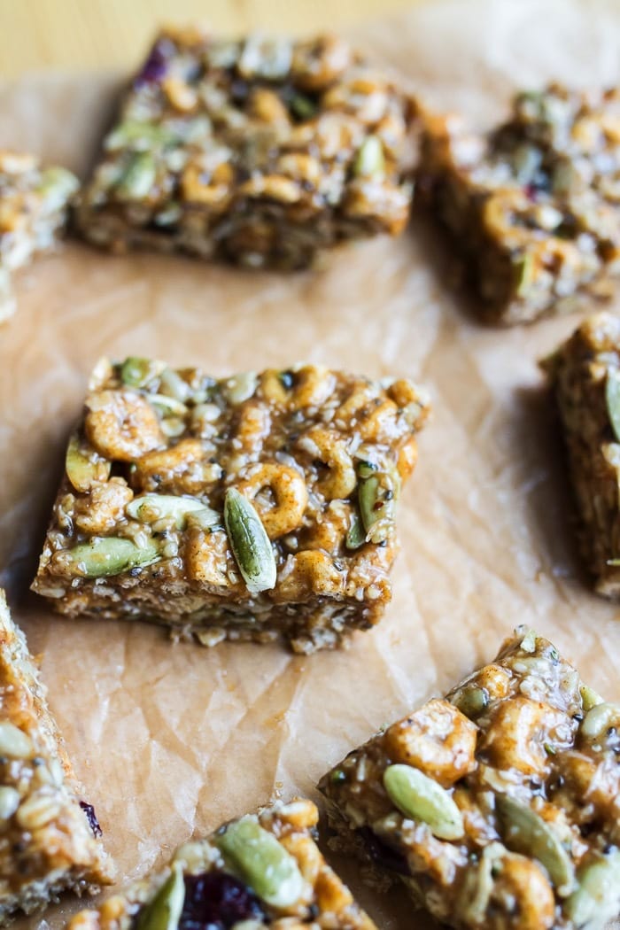These DELICIOUS Pumpkin Spice Cereal Squares are a fall spin on my original recipe for superfood cereal squares. They’re loaded with good for you ingredients and full of pumpkin spice flavor. Gluten and dairy-free! Pumpkin spice cereal squares on parchment paper.