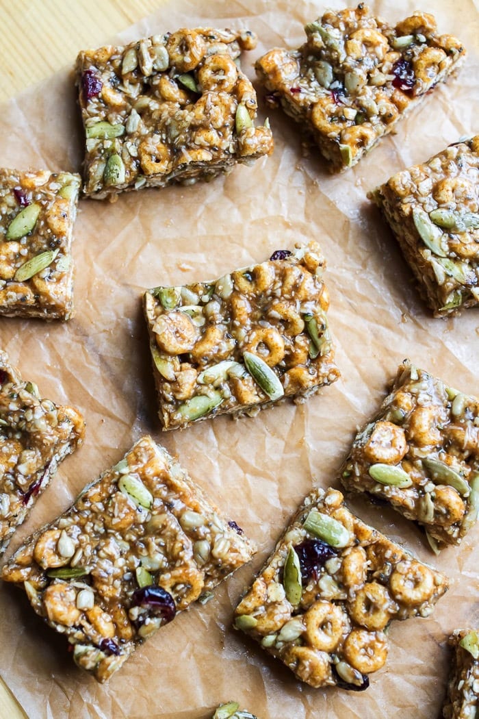 These DELICIOUS Pumpkin Spice Cereal Squares are a fall spin on my original recipe for superfood cereal squares. They’re loaded with good for you ingredients and full of pumpkin spice flavor. Gluten and dairy-free! Pumpkin spice cereal square laying on parchment paper.