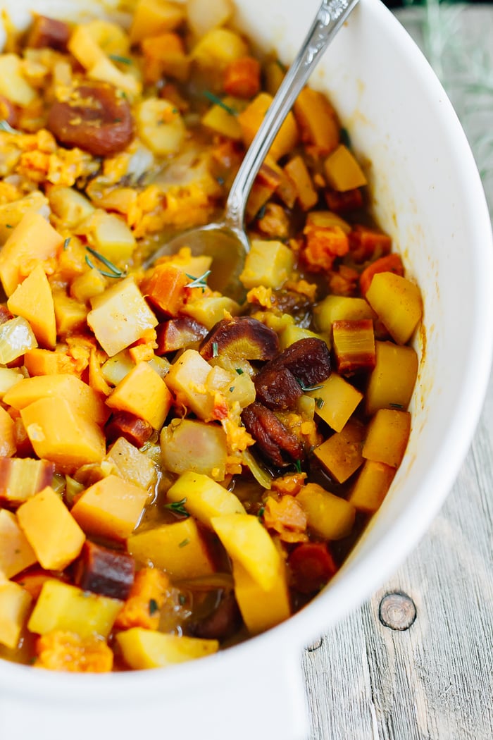 A slow simmered root vegetable tagine with apricots and rosemary! Serve this vegetarian dish as a side or over rice or quinoa for a complete meal. Roasted root vegetables in a dish with dried apricots and topped with rosemary.