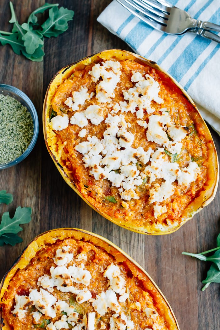 Turn spaghetti squash into a meatless meal with this recipe for stuffed SPAGHETTI SQUASH LASAGNA BOWLS. Made with vegan ricotta and hemp parmesan. Spaghetti squash lasagna boat with sauce and topped with vegan cheese.