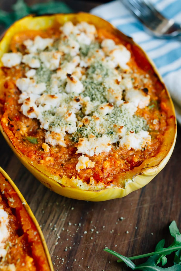 Turn spaghetti squash into a meatless meal with this recipe for stuffed SPAGHETTI SQUASH LASAGNA BOWLS. Made with vegan ricotta and hemp parmesan. Vegan spaghetti squash lasagna bowls topped with vegan cheese.