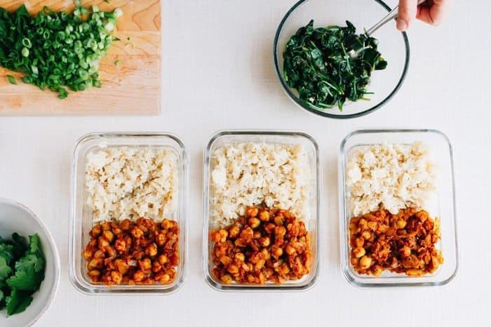 Curried Chickpea Meal Prep Bowls -- the BEST vegan meal prep recipe Three curried chickpea meal prep bowls in glass containers served alongside brown rice.
