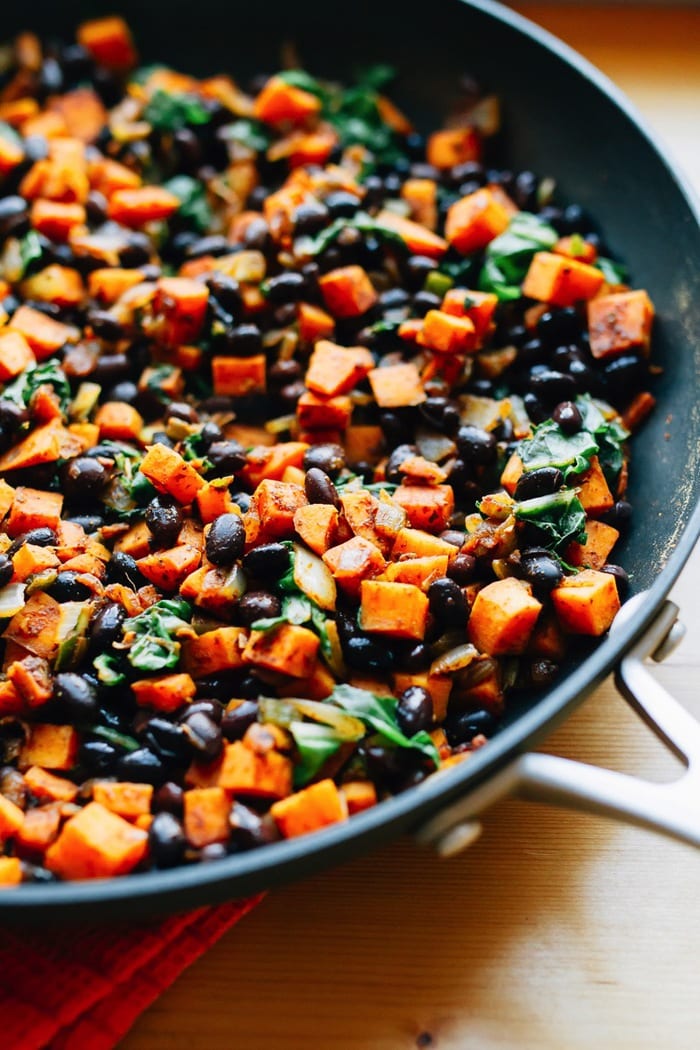 Cooked Sweet Potato and Black Bean Mixture for the Enchilada Bake Black beans and sweet potato in a pan.