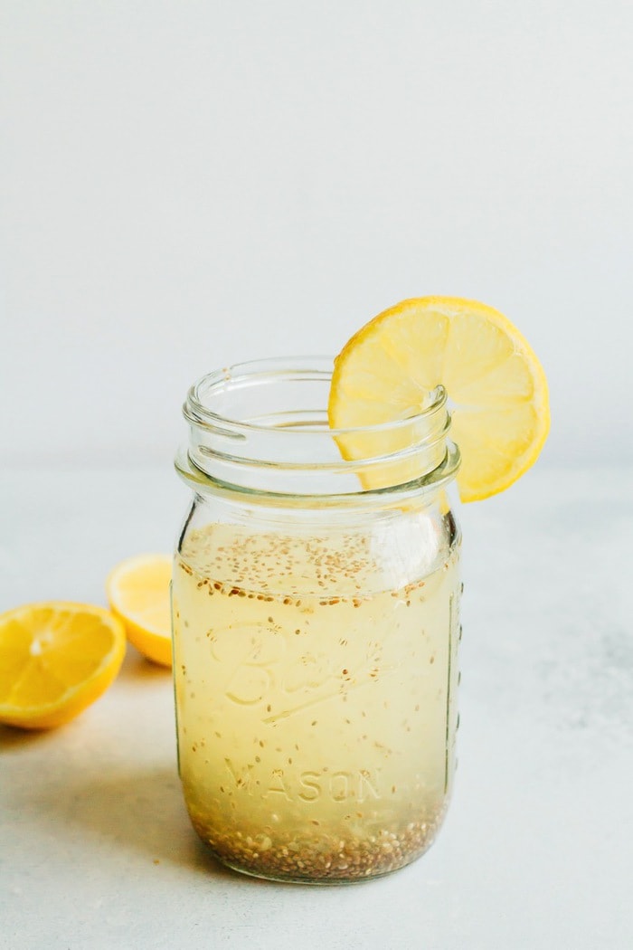 Lemon Chia Fresca in a clear mason jar with a slice of lemon.