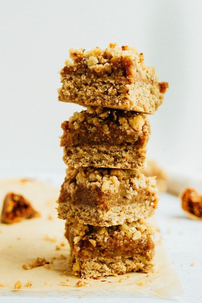Wholesome Fig Jam Crumble Bars you can feel good about enjoying for breakfast, a snack or dessert. They’re loaded with healthy fats and naturally sweetened. A stack of four fig crumble bars.