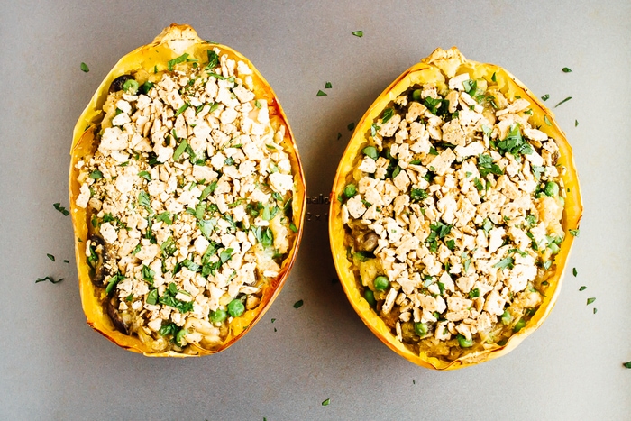 A healthy spin on a comfort food classic, these spaghetti squash tuna noodle casserole boats are filled with loads of creamy noodle goodness. Gluten-free, dairy-free, low-carb and paleo! Two large spaghetti squashes stuffed with a tuna casserole.