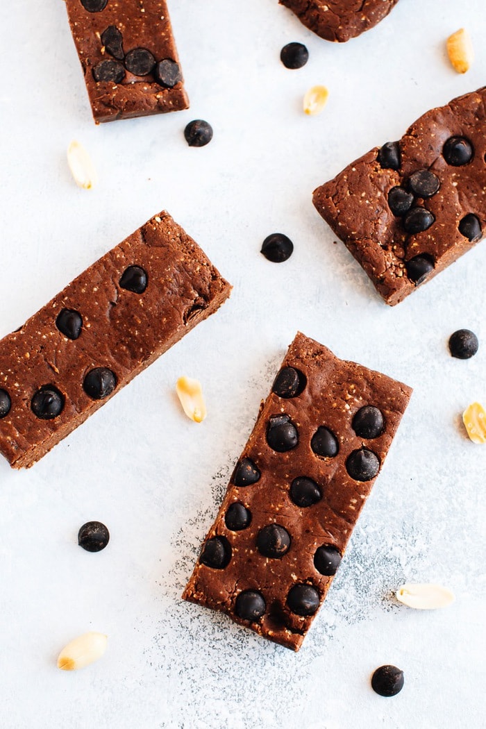 Pin this recipe for Homemade Peanut Butter Chocolate Protein Bars! Protein bars with peanuts and chocolate chips sprinkled around