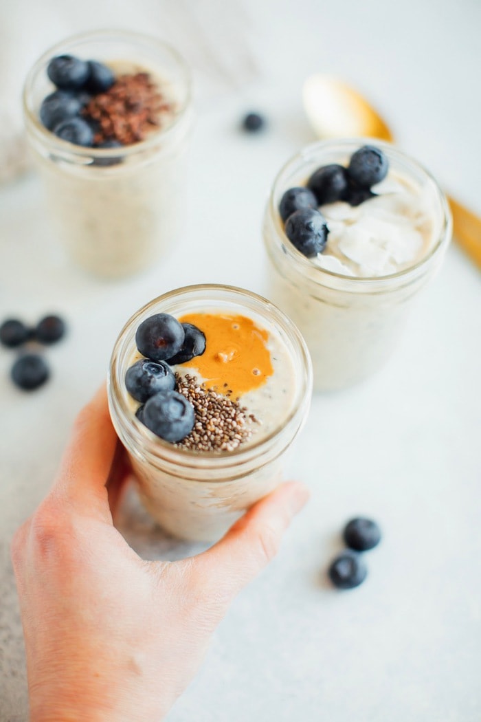 Grain-Free overnight "oats" in a jar being held by a woman's hand. Grain-Free overnight "oats" in a jar being held by a woman's hand.