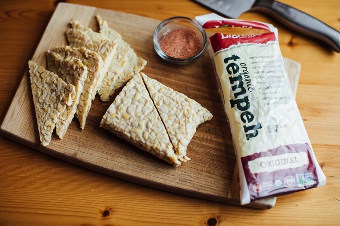 Slices of tempeh being sliced and prepped for making bbq tempeh chips. Slices of tempeh being sliced and prepped for making bbq tempeh chips.