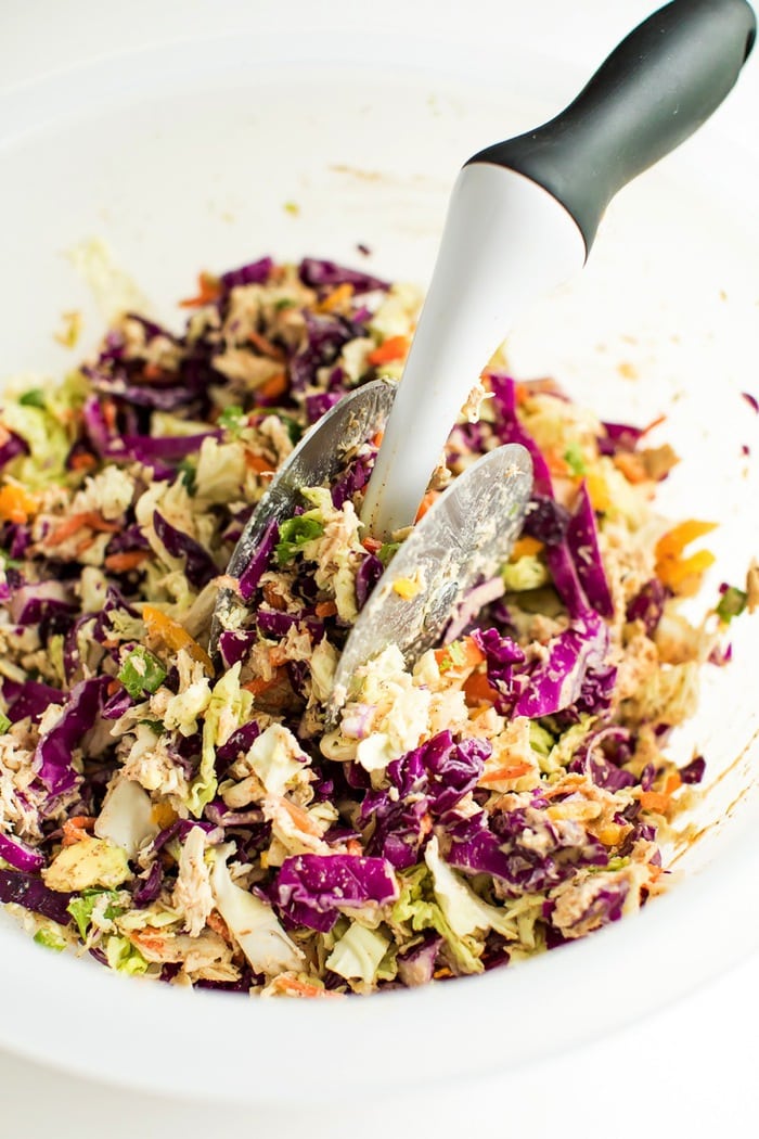 Asian salad being chopped in an OXO salad chopper bowl.