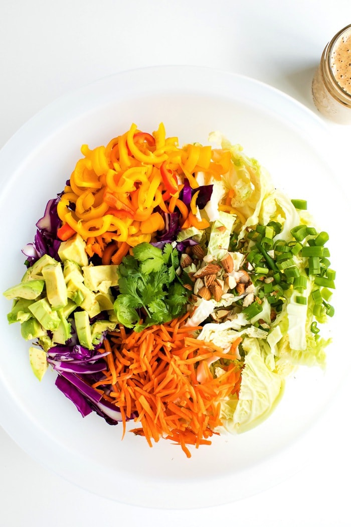 PIN THIS --> Asian Chopped Salad All the ingredients for an Asian chopped salad in a large salad chopper bowl.
