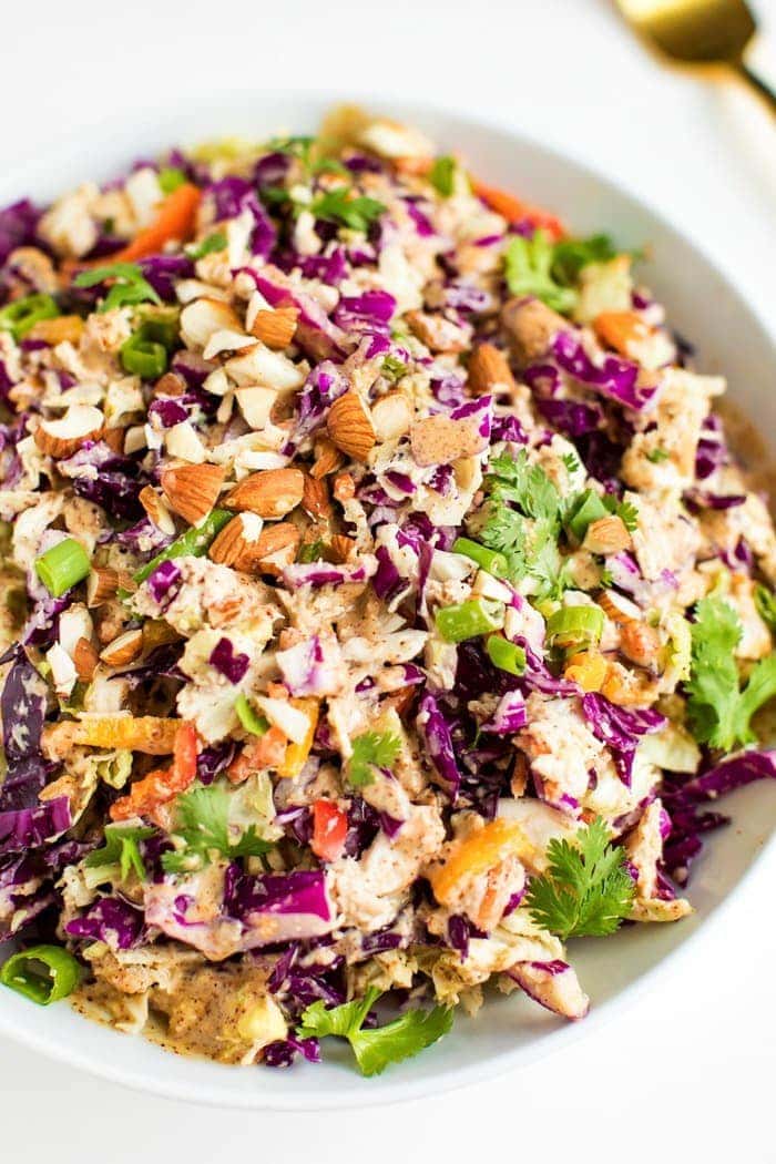 PIN THIS --> Asian Chopped Salad Asian chopped salad in a white bowl with chopped almonds on top.