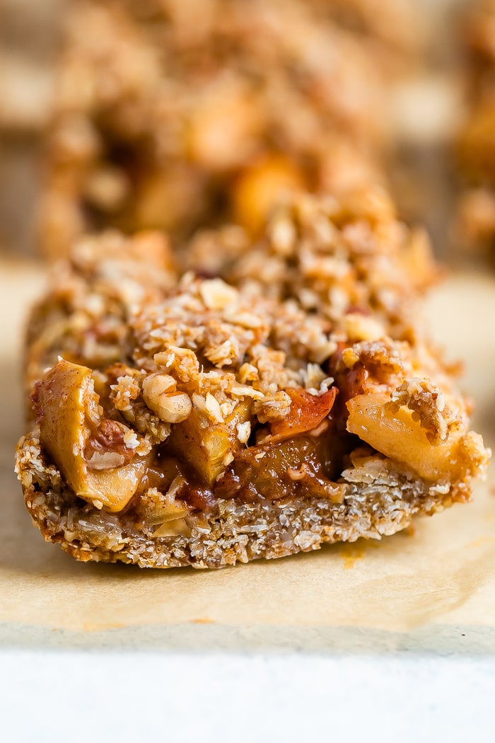 Apple crumble bar on parchment paper.
