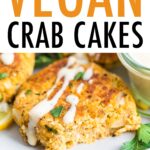 Close up photo of a vegan crab cake drizzled with a creamy dressing and fresh parsley.