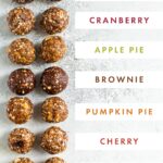 Photo of 10 different flavors of energy balls with labels for their flavors.