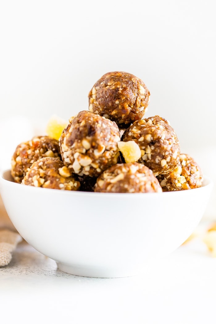 Gingerbread energy balls in a white bowl.