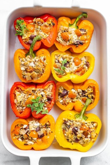 Baking dish with 8 tuna stuffed bell peppers.