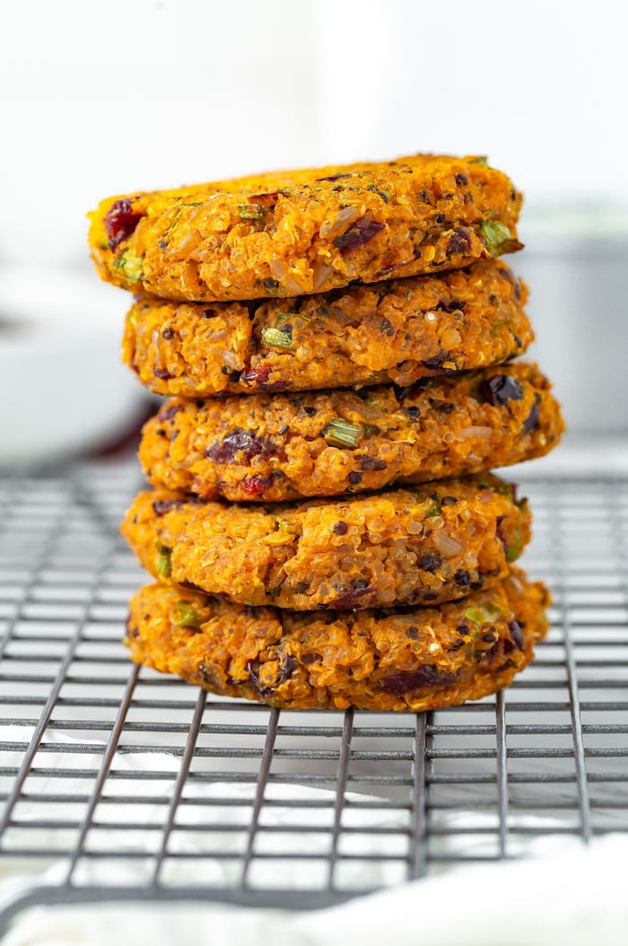 Five sweet potato quinoa cakes stacked.