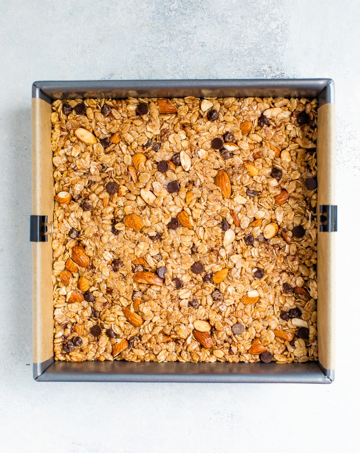 Square pan with chocolate chip almond granola bars before being cut.