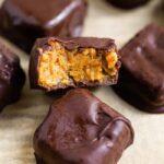 A homemade Butterfinger bite with a bite taken from it to see the peanut butter filling.