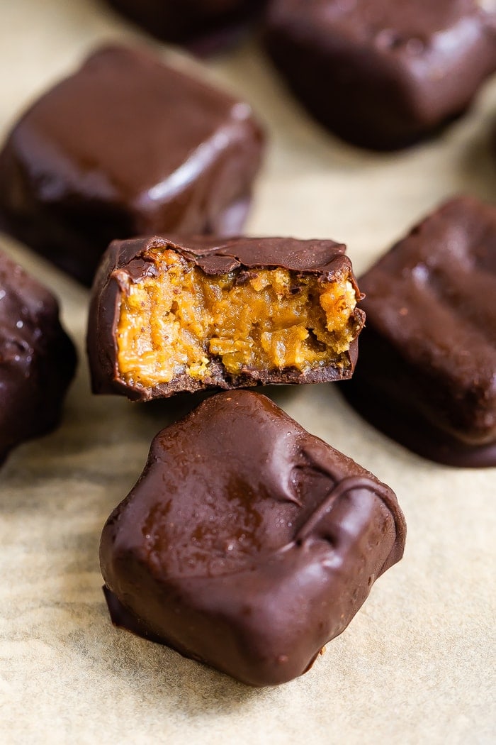 A homemade Butterfinger bite with a bite taken from it to see the peanut butter filling.