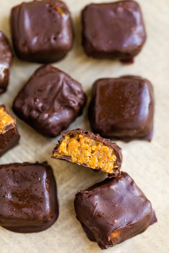 Overhead photo of chocolate covered butterfinger bites on a pan.