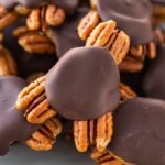 Close up photo of homemade turtle candies made with pecans, date caramel and chocolate.